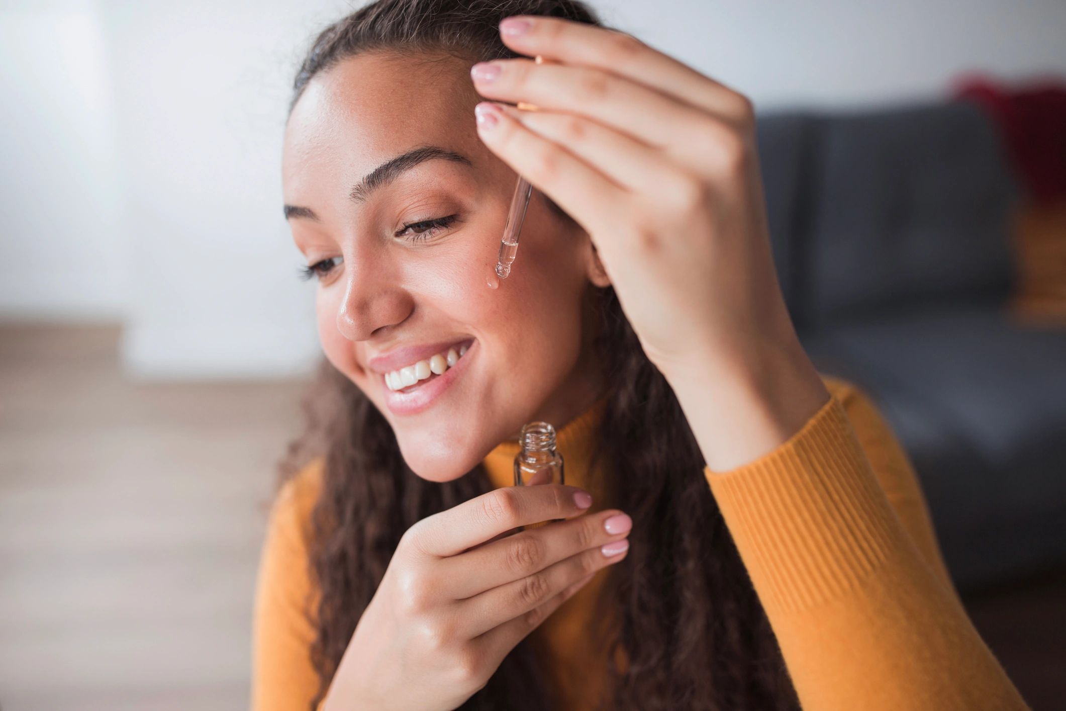 Woman applying skin care product — Denver spa facial guide